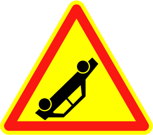 Triangular traffic sign with a yellow background and red border depicting an overturned car to warn of an accident ahead.