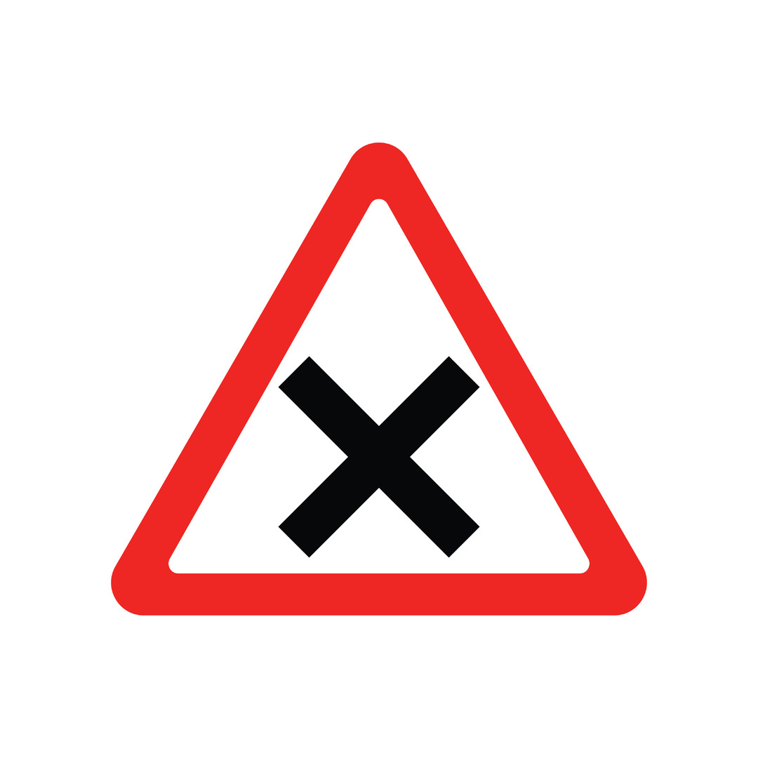 Red triangle with white centre and a black cross in the middle to indicate upcoming crossroads.