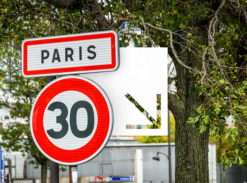 Paris road signs including a 30km/h limit, useful for drivers using car hire excess insurance while travelling in France.