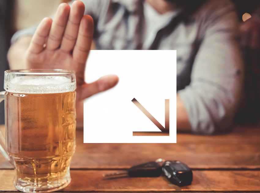 Person refusing alcohol next to car keys, illustrating international drink driving laws and the protection offered by car hire excess insurance.