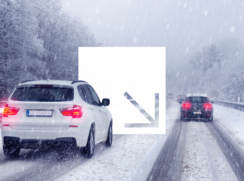Cars travelling on a snowy road during heavy snowfall, showing why car hire excess insurance matters in risky winter conditions.