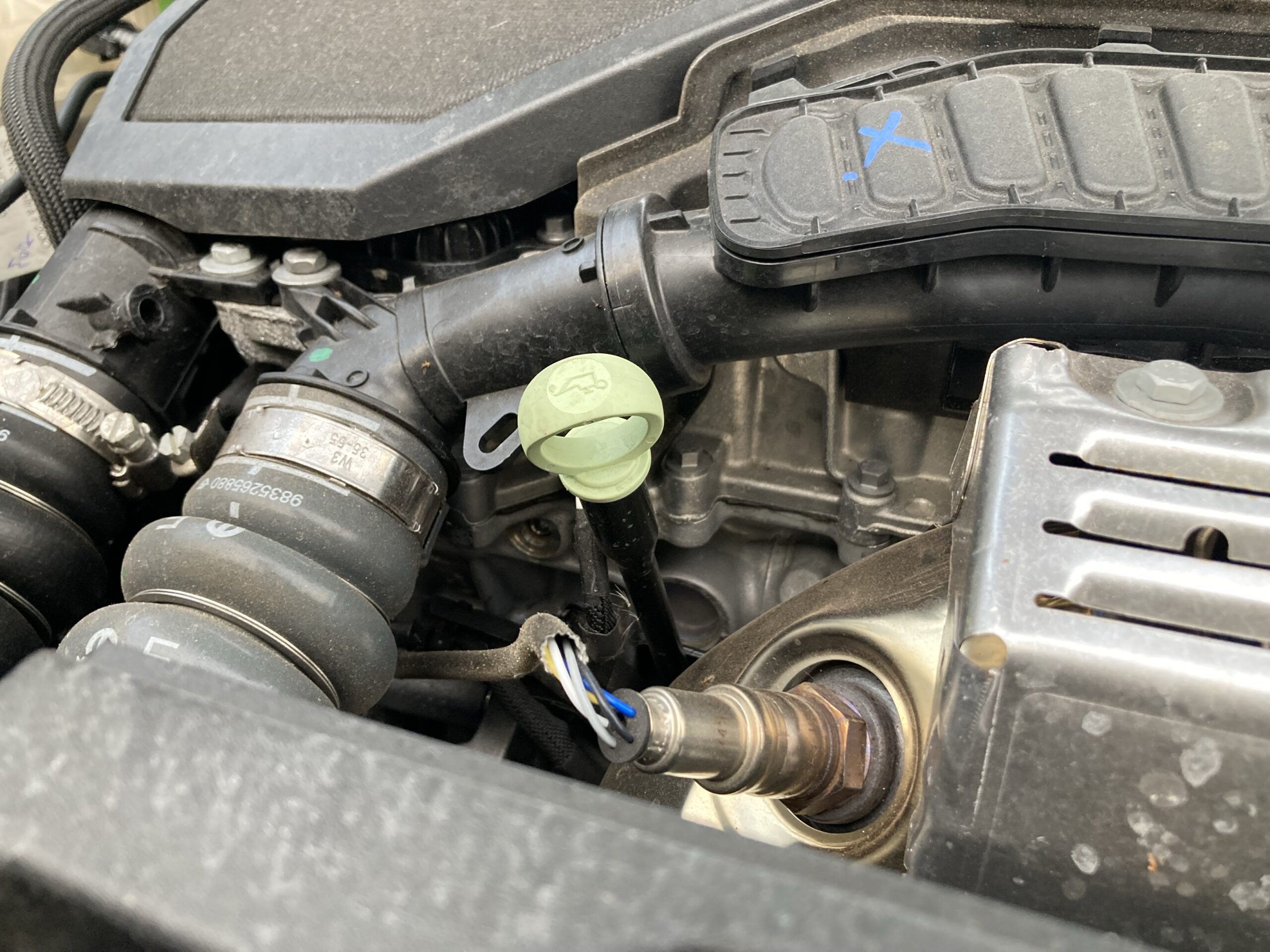 Oil reservoir dipstick located underneath car bonnet