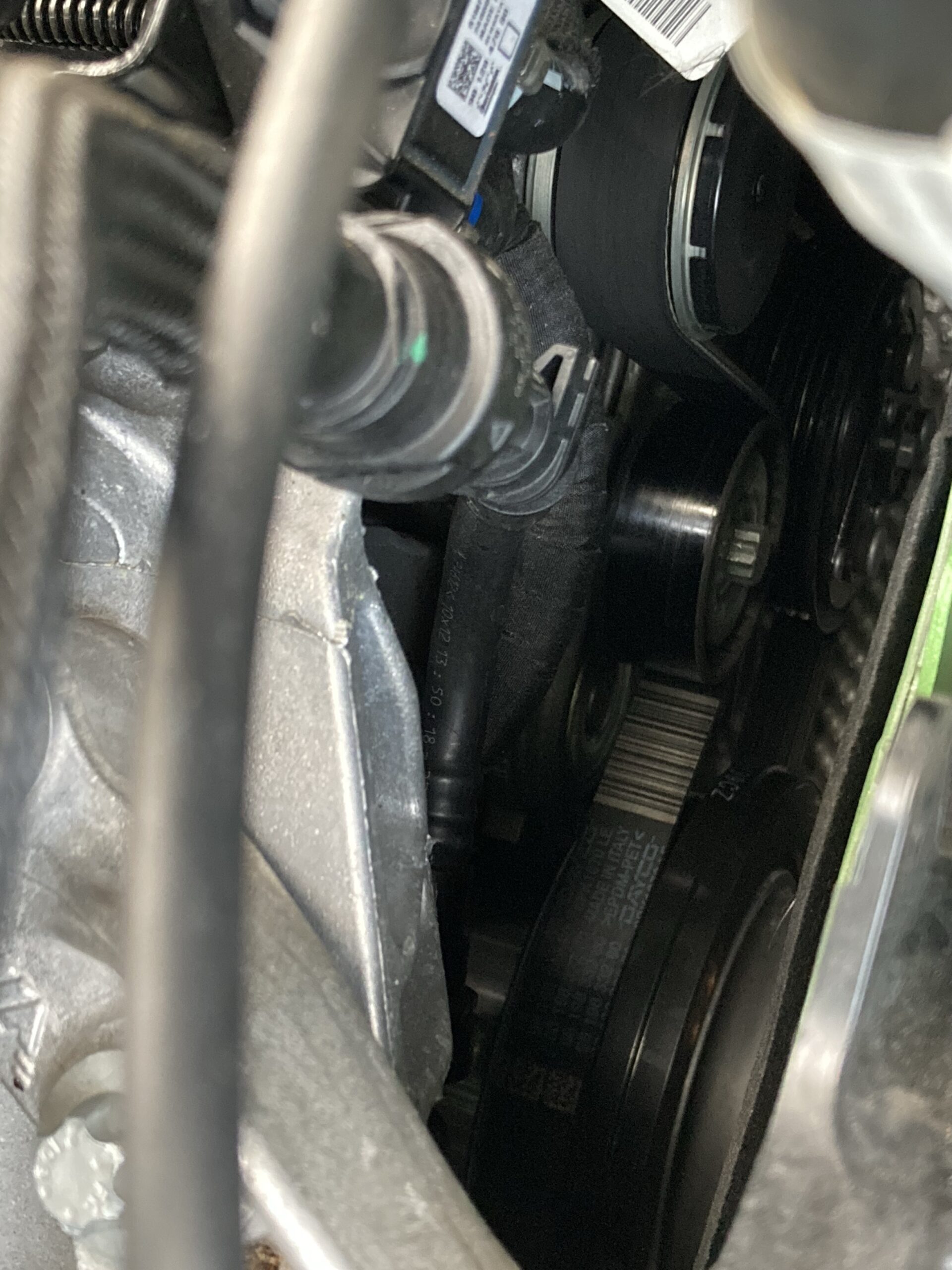 Pulley and auxillary belt underneath car bonnet