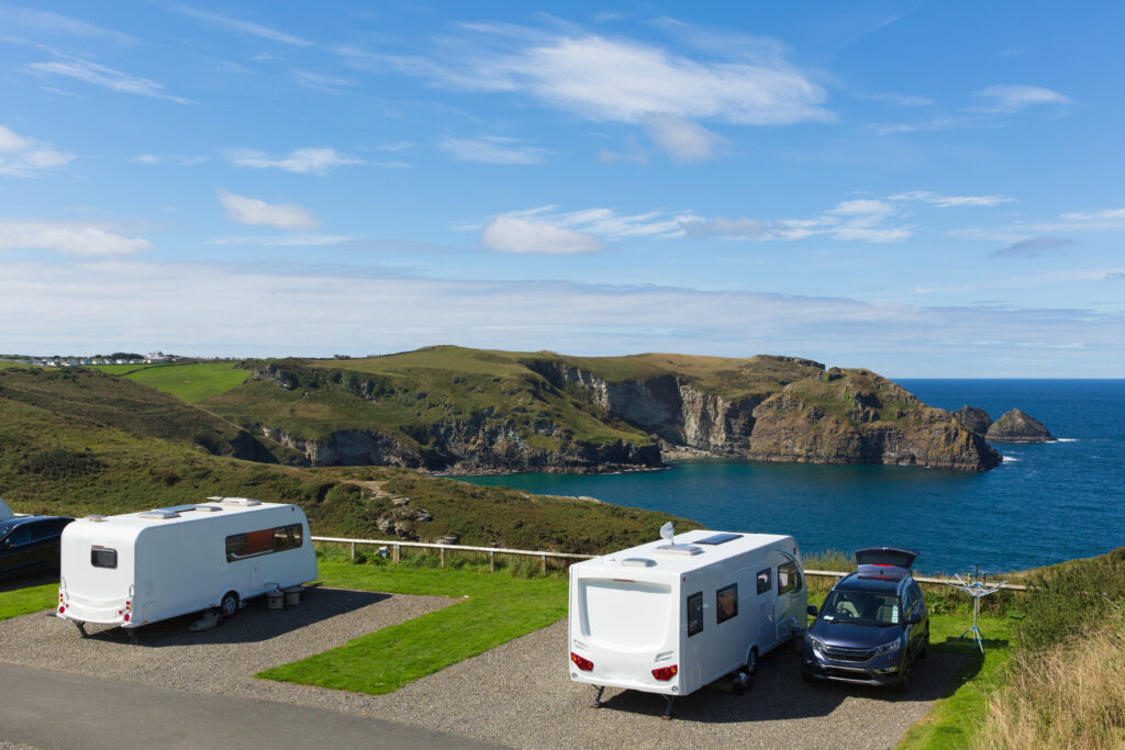 Parked caravans on hillside with view over the sea
